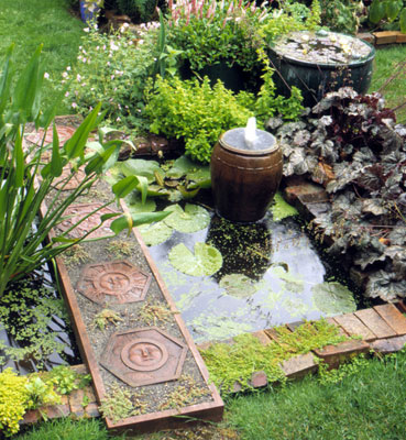 Software  Architectural Design on Small Pot Fountain Surrounded By Lilypads In A Brick Lined Pond