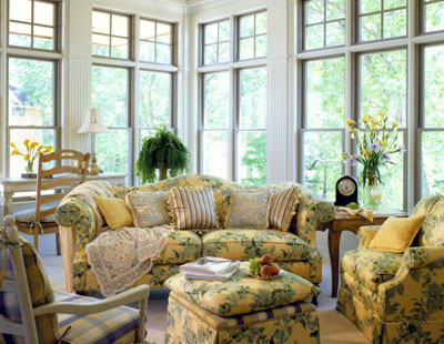 sun room with couches and chairs in a floral pattern